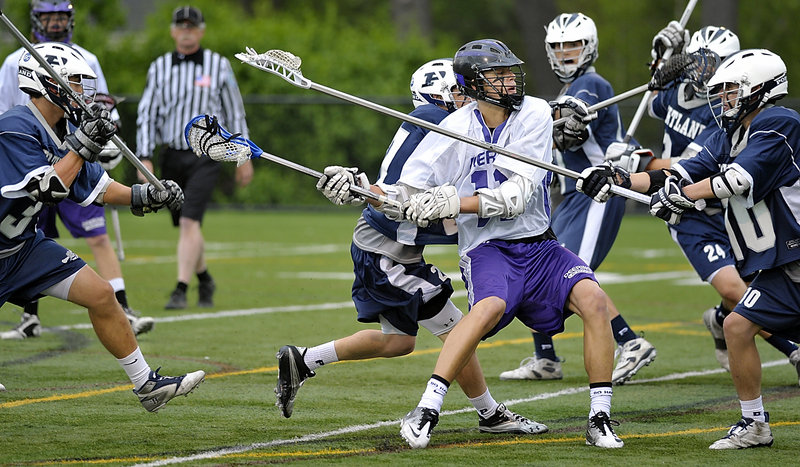 Anthony Verville of Deering looks for an opportunity Tuesday night while being swarmed by the Portland defense during their Eastern Class A schoolboy lacrosse quarterfinal. Deering won and will meet Lewiston in the semifinals.