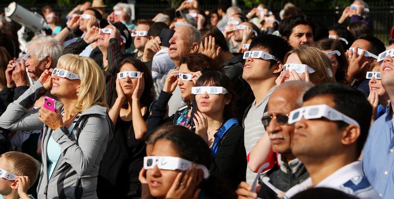 Venus viewers wearing special glasses to protect their eyes from the sun gather to watch the transit of Venus at the University of Western Ontario in London, Ontario, on Tuesday. The planet’s trip across the face of the sun was the last that will be visible for another 105 years.