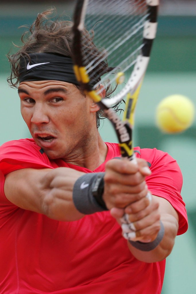 Rafael Nadal returns a shot against Nicolas Almagro in the French Open quarterfinals Wednesday in Paris. Nadal advanced, 7-6 (4), 6-2, 6-3.