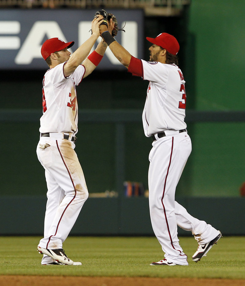 Bryce Harper, left, and Michael Morse celebrate after the Nationals beat the New York Mets 5-3 Wednesday night in Washington.