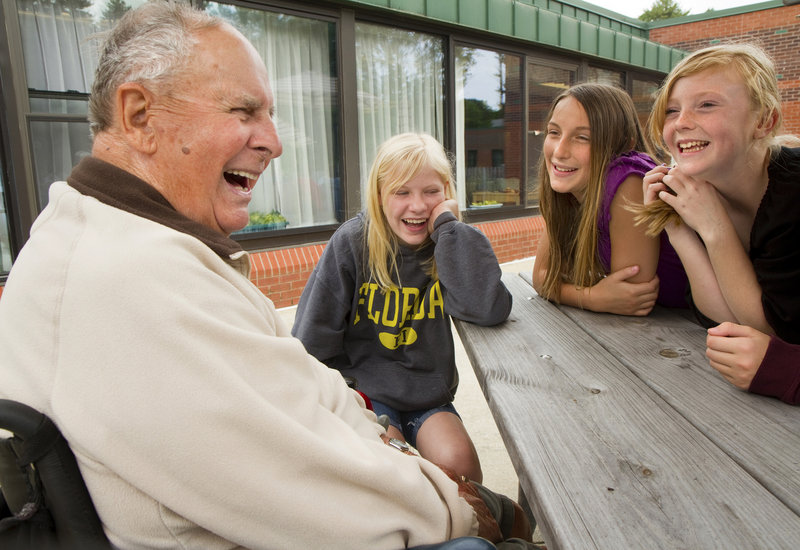 World War II veteran Fernand Gaudreau, 90, shares a laugh Thursday with Scarborough sixth-graders, from left, Jessie Flaherty, Morgan Jackson and Sydnie Pike, at the Maine Veterans’ Home.