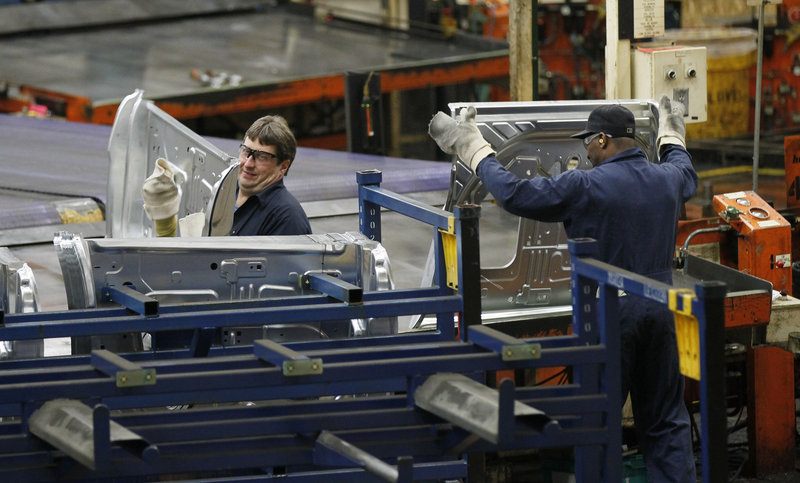 Auto workers at the Ford Stamping Plant in Chicago Heights, Ill., stack the inner door panel for a Ford Explorer in April. Ford is among the U.S. companies feeling the impact of Europe’s financial crisis.