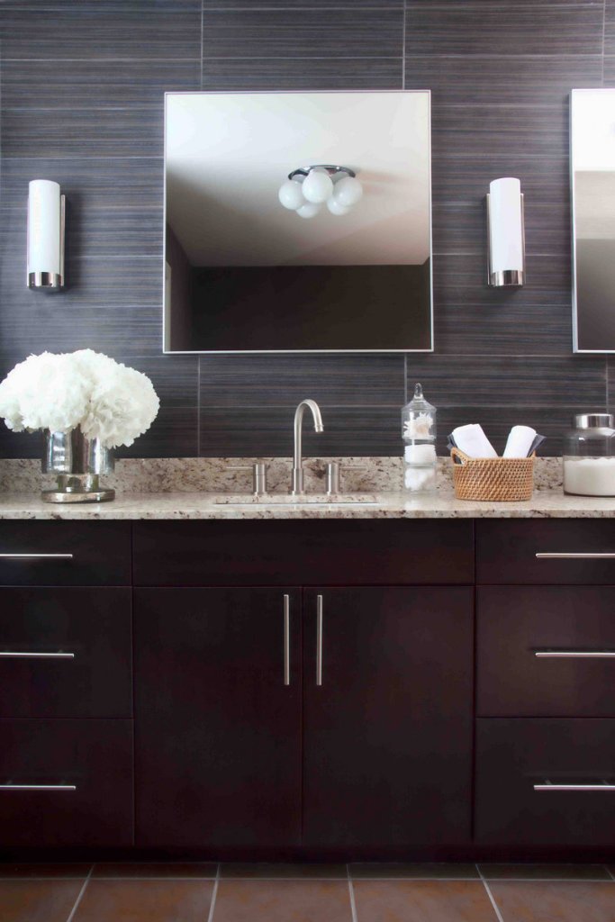 This master bathroom designed by Brian Patrick Flynn features 24- by 6-inch porcelain tiles on the walls. More designers are promoting the idea of using tile floor-to-ceiling. “It makes the entire room more cohesive, and it can also give the illusion that a space is larger than it actually is,” says Flynn.