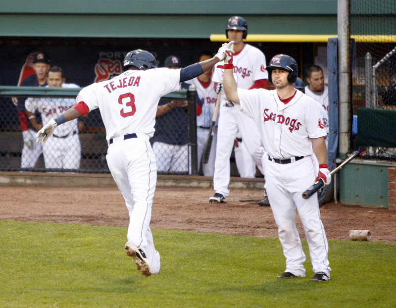 Oscar Tejeda of the Portland Sea Dogs is welcomed by Dan Butler after hitting a solo home run in the second inning Friday night. Portland went on to beat the Richmond Flying Squirrels 4-1 at Hadlock Field.