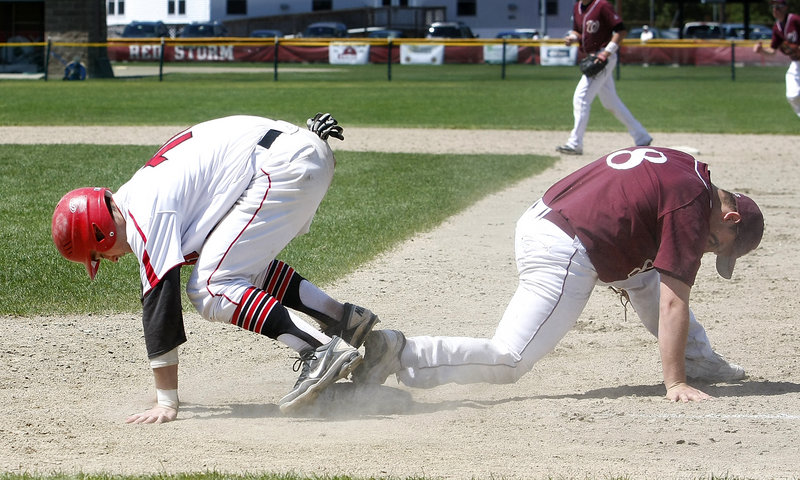 Robbie Hamilton, right, of Windham keeps his foot on the first-base bag and gets the out on Conor McCann of Scarborough to complete a double play Saturday in the fifth inning of Scarborough’s 7-0 victory in a Western Class A baseball semifinal.