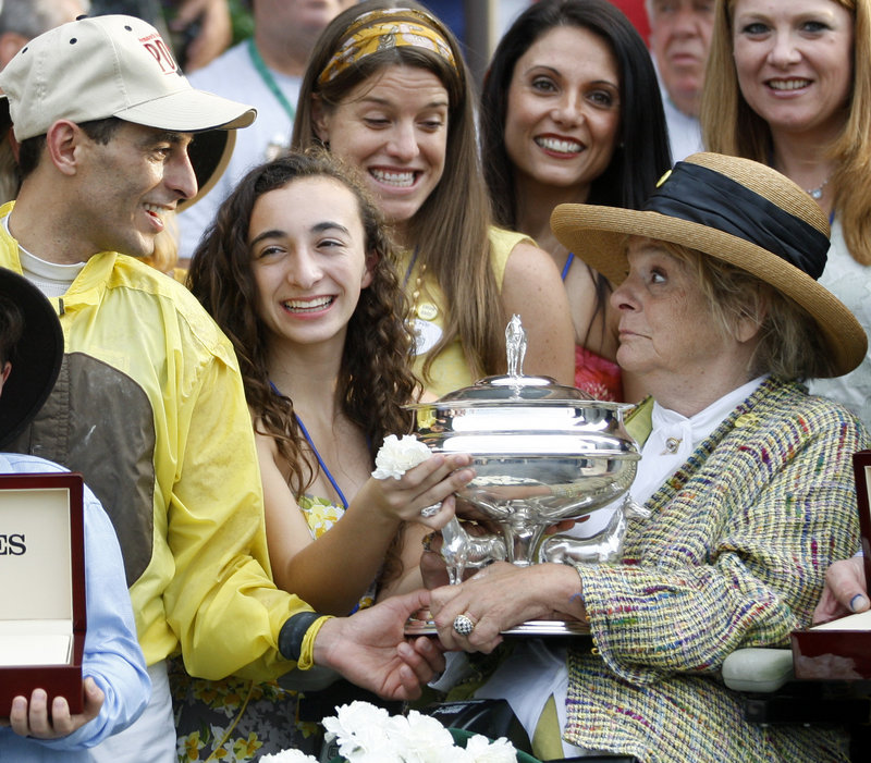 Phyllis Wyeth, right, the owner of Union Rags, is handed the winning trophy Saturday by jockey John Velazquez after Union Rags captured the Belmont Stakes. Wyeth is a part-time resident of Tenants Harbor, Maine.