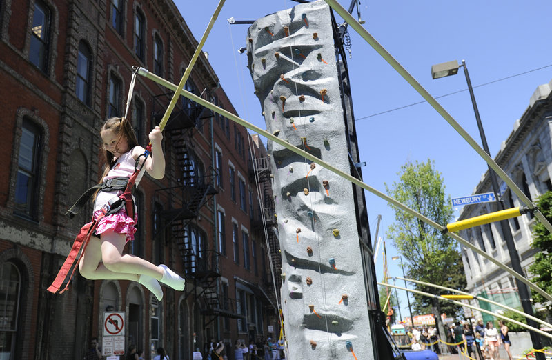 Seven-year-old Sophia Tanguay of Waterboro jumps on the Maine Rock Gym’s Extreme Air Jumper during the Old Port Festival.