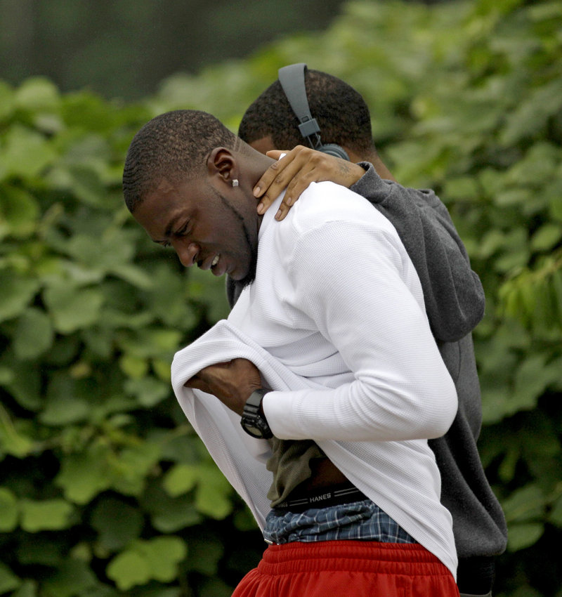 Mourners leave a housing complex at the scene of an overnight shooting Sunday in Auburn, Ala. A gunman killed three people, including two former Auburn University football players.