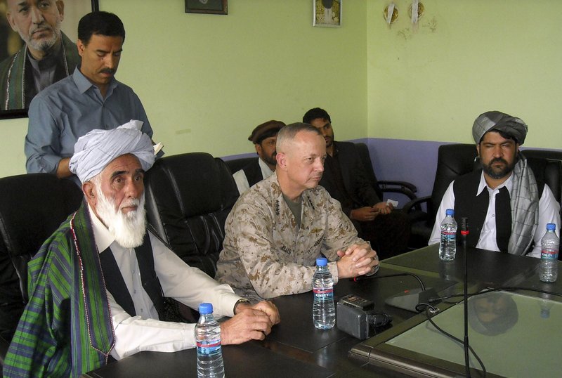 Gen. John Allen, center, commander of Western forces in Afghanistan, meets with Allhaj Mohammad Tahir Sabari, governor of Logar province, on Friday. NATO reached an agreement Saturday not to bomb residential buildings.