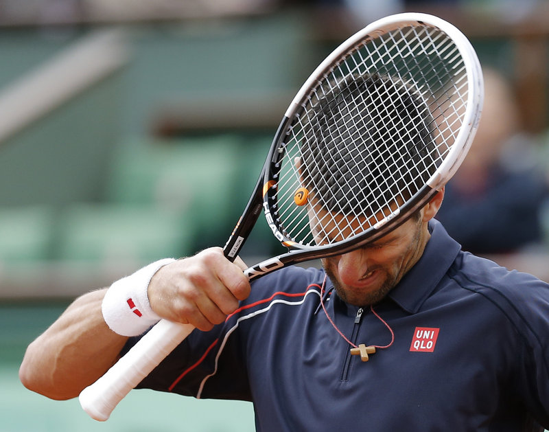 Racket meets head as Novak Djokovic laments a lost point. He was trying to become only the third man to win four major tournaments in a row.