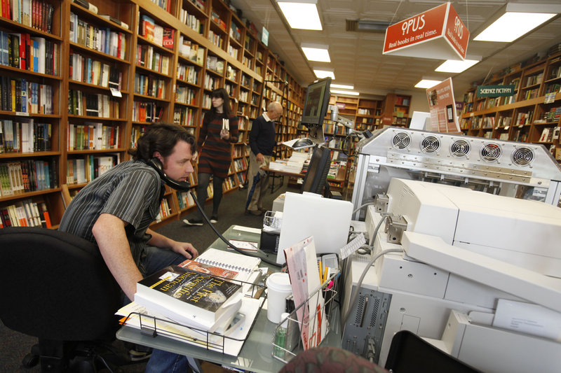 Bill Leggett works on the Espresso Book Machine, nicknamed “Opus,” at Politics and Prose bookstore in Washington, D.C. Self-publishing and copying out-of-print editions have been made easier since the machine by On Demand Books debuted in 2006.