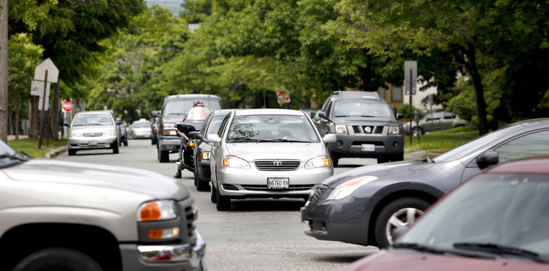 Cars are stopped on State Street at the intersection with Congress Street in Portland on Monday. A plan to make the street two-way could make it more pedestrian-friendly.