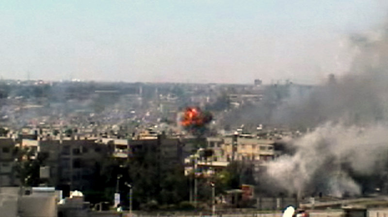 This image taken from amateur video shows explosions rocking the central Syrian city of Homs on Monday.