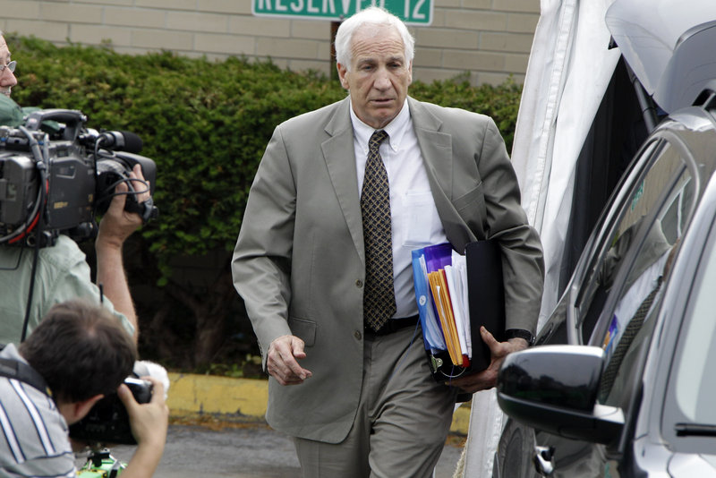 Former Penn State assistant football coach Jerry Sandusky leaves the courthouse Monday after the first day of his trial in Bellefonte, Pa., on 52 counts of child sexual abuse.