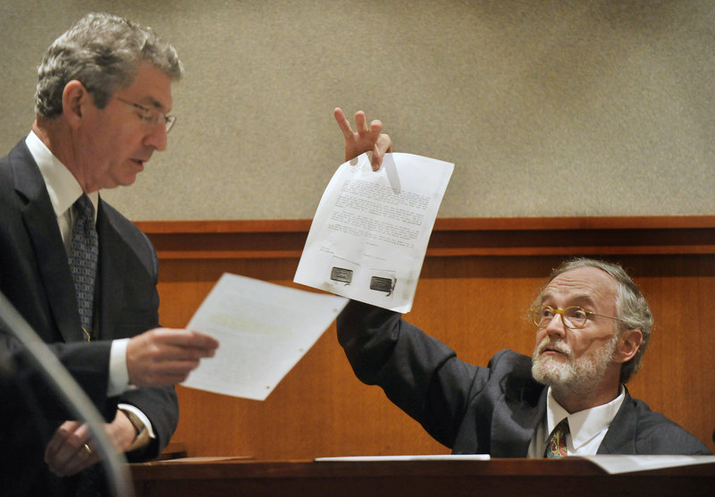 Deputy Attorney General William Stokes, left, verifies pieces of evidence with Thomas Connolly, Dennis Dechaine’s former defense attorney, who was called as a witness at the hearing on Dechaine’s latest effort to obtain a new trial.