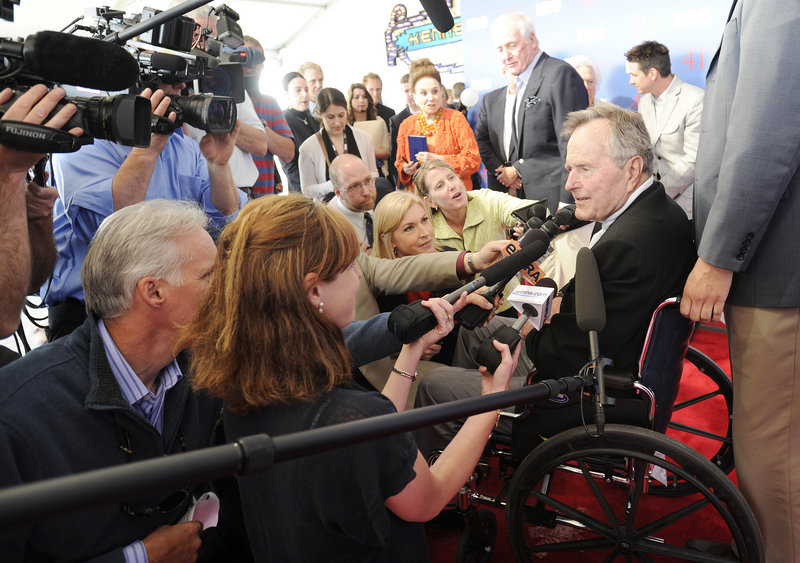 Reporters mob former President George H.W. Bush on the red-carpeted entrance to the temporary Kennebunkport Playhouse on Tuesday where he celebrated his 88th birthday with a special screening of “41,” the new HBO documentary about his life. The screening was held inside a metal-and-glass structure on the grounds of St. Ann’s Episcopal Church.