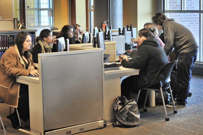 Students work at computers in the University of Southern Maine’s Glickman Library in Portland. A reader says improving USM and the University of Maine at Orono will boost Maine’s economy.