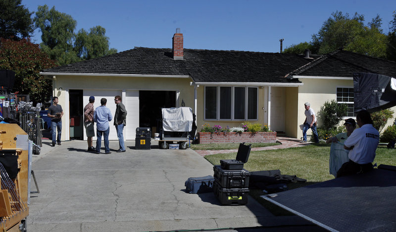A vertical garage door is replaced with sliding doors at Steve Jobs’ childhood home in L.A. as filmmakers prepared this week to begin shooting the feature film “jOBS.”