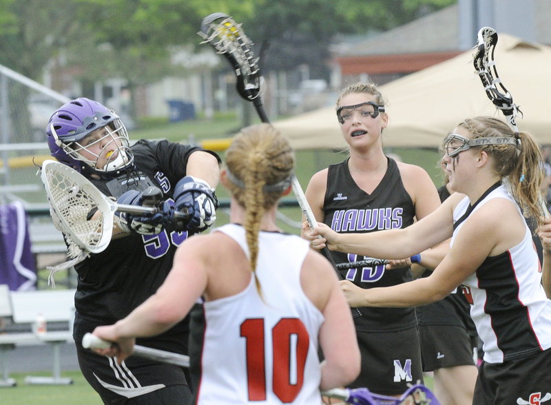 Kelsey Howard, right, of Scarborough fires a shot past Marshwood goalie Meghan Lewis to score the fourth goal for the Red Storm during a 13-3 victory Wednesday in the Western Class A girls’ lacrosse final. Scarborough will seek its third consecutive state championship Saturday.