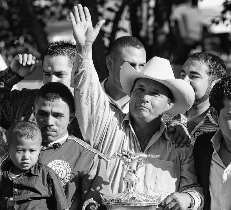 Jose Trevino Morales, center, acknowledges the crowd after one of his horses won a race in New Mexico in 2010.