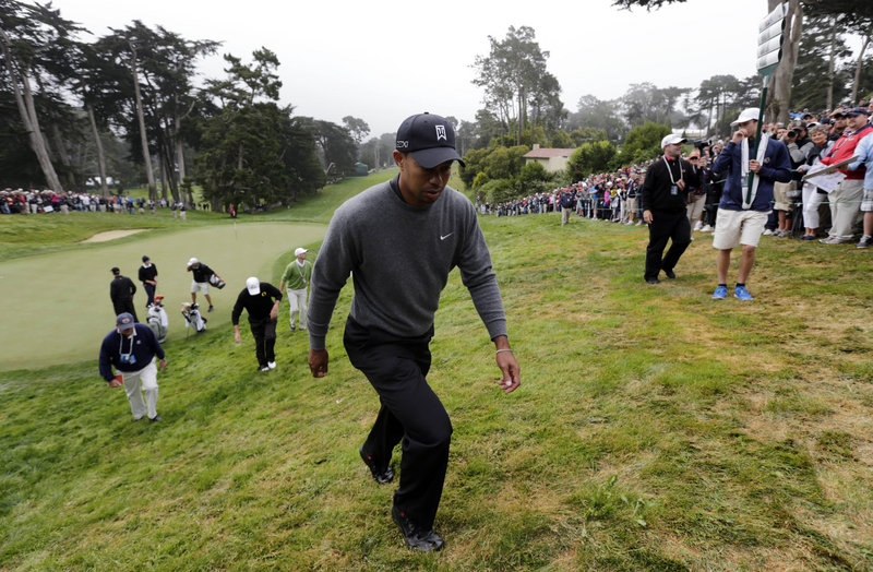Tiger Woods trudges up a hill off the 18th green Wednesday during a practice round for the U.S. Open at the Olympic Club, a course that was essentially built on the side of a giant sand dune that leads toward Lake Merced.