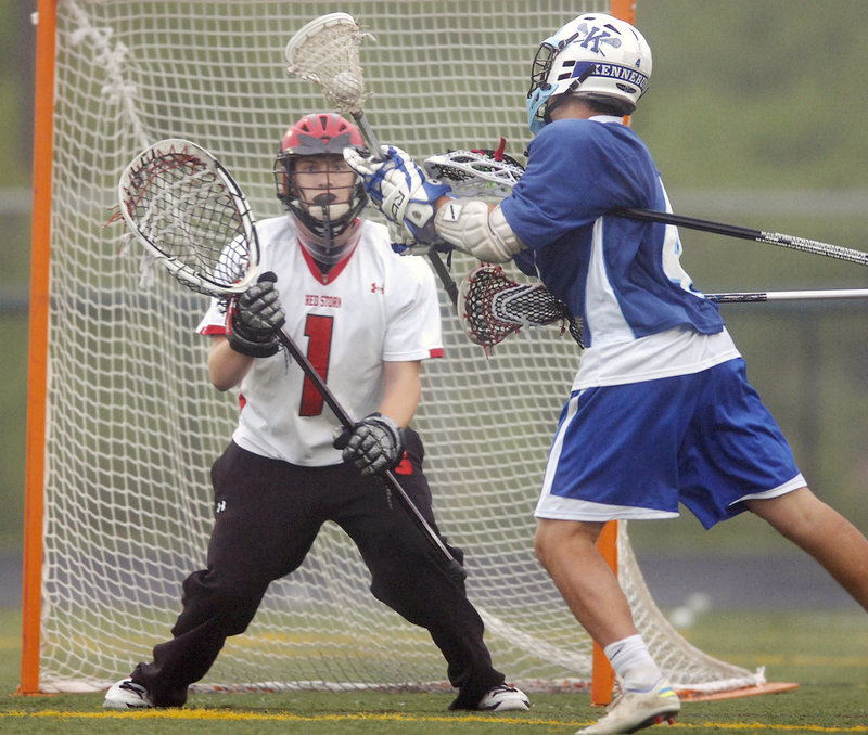 Scarborough goalie David Pearson braces for a shot by Kennebunk’s Harrison Hall. Pearson limited Kennebunk to three goals as Scarborough advanced to another state final.