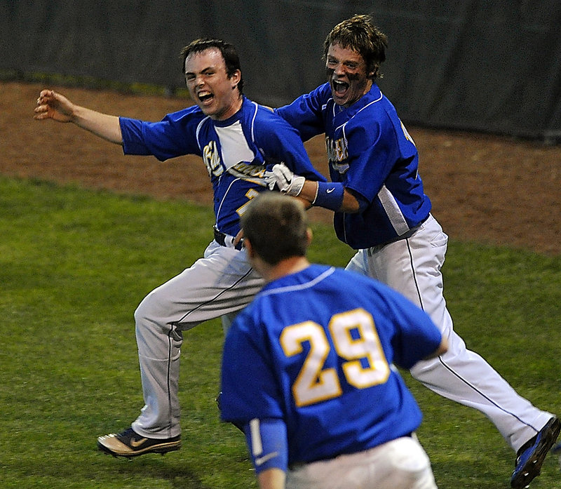 Connor Murphy is chased by his teammates after scoring in the bottom of the eighth inning to give Falmouth a 1-0 win over Cape Elizabeth in the Western Class B baseball final at St. Joseph’s College.