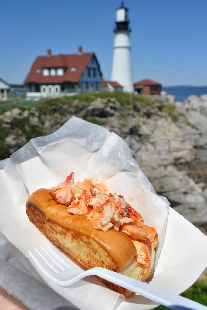 With scenic Fort Williams Park in Cape Elizabeth – and Portland Head Light – as a backdrop, the Bite Into Maine food truck serves a variety of nontraditional lobster rolls, including the curry roll.