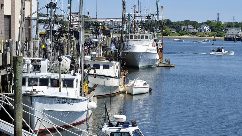 A lobster boat heads out past fishing boats at the Portland Fish Pier on Friday. Maine’s groundfishing fleet has dwindled dramatically in recent years, with lobster boats replacing trawlers, gillnetters and other vessels in many ports.