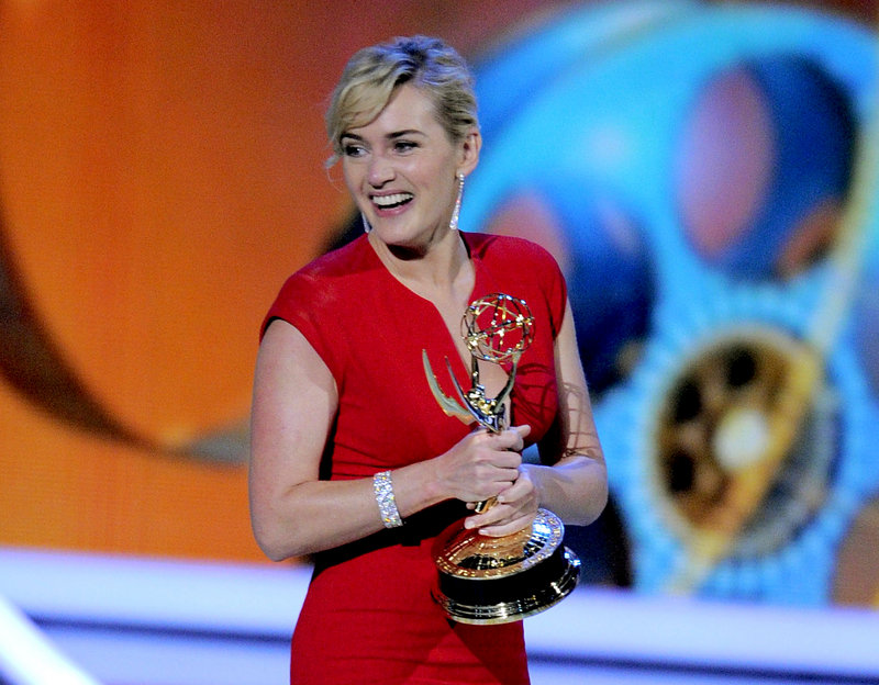 Kate Winslet, shown accepting an award in 2011, says she’s “very proud to be a Brit” after being named a Commander of the Order of the British Empire.