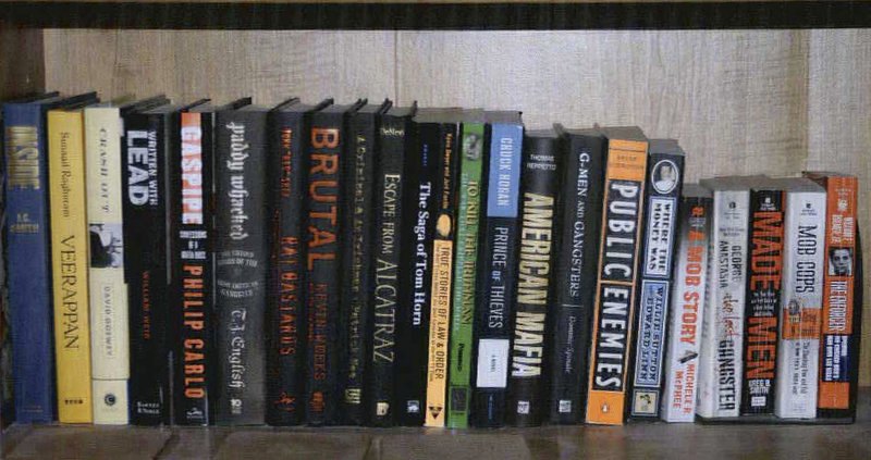 This 2011 photo provided by the U.S. attorney’s office shows a shelf containing books about gangsters and crime in the Santa Monica, Calif., apartment where Whitey Bulger and Catherine Greig hid before their arrest in June 2011.