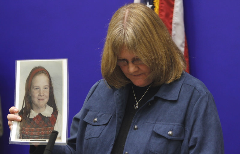 Becky Ianni holds a photo of herself as a child during a news conference on legislation dealing with the statute of limitations on how long victims of sex abuse have to file civil lawsuits at the Capitol in Richmond, Va., on Jan. 27, 2011.