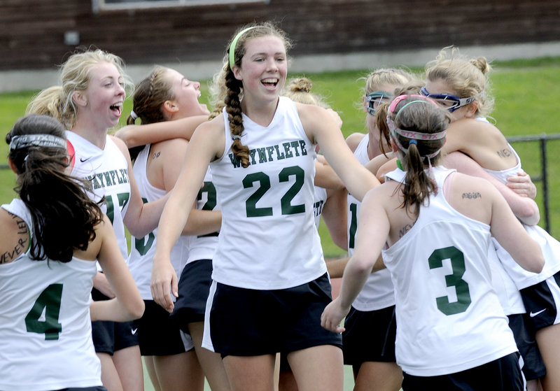 Jo Moore, center, and the Waynflete girls’ lacrosse team celebrated their second straight Class B title after beating Freeport, 16-5.
