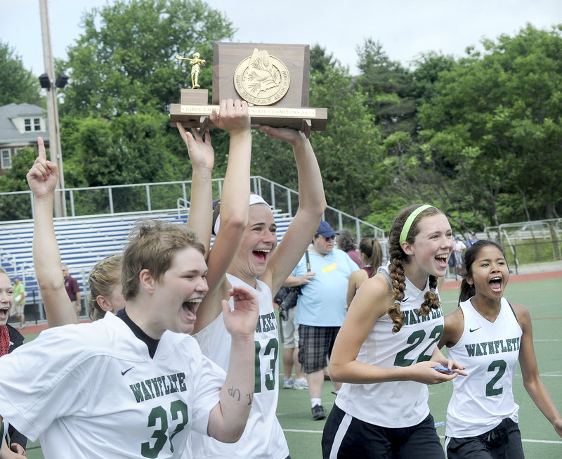 Left to right, Katherine Torrey, Sadie Cole, Jo Moore and Hannah Thompson-Greaves celebrate Saturday after Waynflete’s victory in the Class B girls’ lacrosse final.