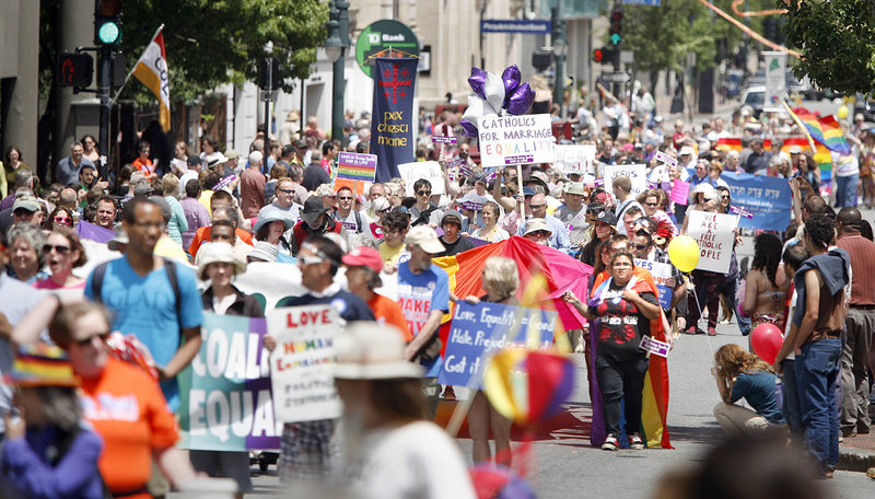 The Southern Maine Pride Parade makes its way down Congress Street in Portland on Saturday. Many marchers carried signs in support of the upcoming vote on gay marriage.