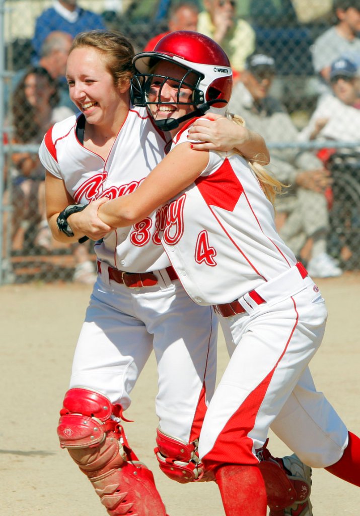 Nicole Rugan, left, hugs Alyssa Brochu after Brochu scored the second run for Cony in the fourth inning Saturday. The Rams went on to beat South Portland 2-0 and capture the Class A softball state championship.