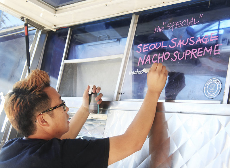 Yong Kim writes specials at the Seoul Sausage truck.