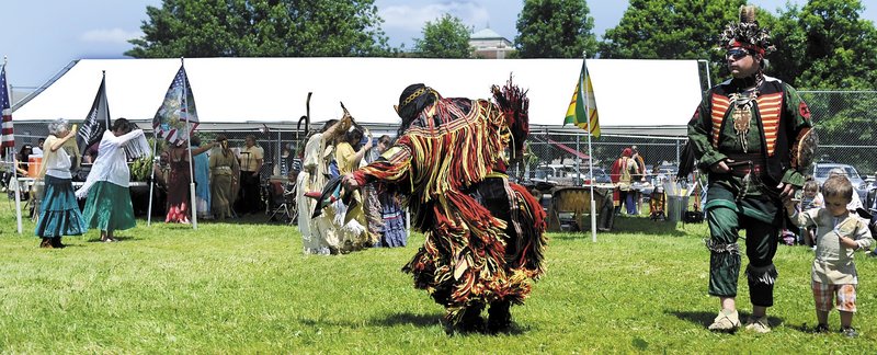 Participants clad in American Indian regalia dance Sunday during the Honoring Our Veterans Powwow at Togus.