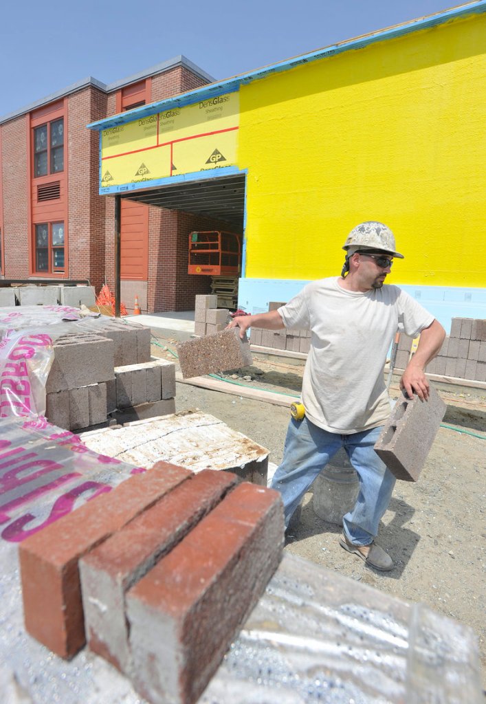 Jared Shaw, a mason tender from South Paris, moves bricks at a newly built section of Lake Region High School. The $13.8 million project, begun in the fall of 2010, addresses concerns in accreditation reports over the 42-year-old building’s air quality and space constraints.