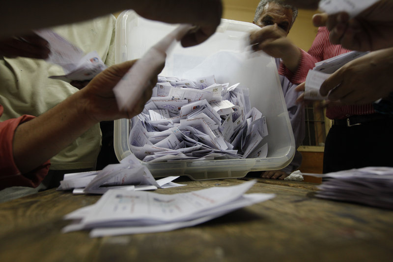Egyptian election officials count ballots at a polling center in Cairo on Sunday during the second day of the presidential runoff. Final official results aren’t expected until Thursday.