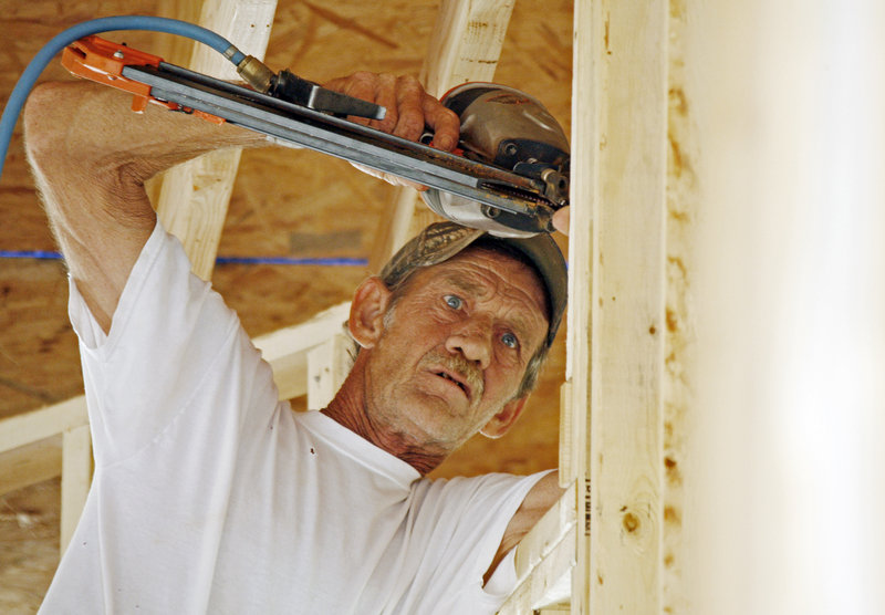 John Knight uses an air hammer as he frames a new house in the Patrick Farms community in Pearl, Miss., this month. Confidence among U.S. builders has risen in seven of the last nine months.