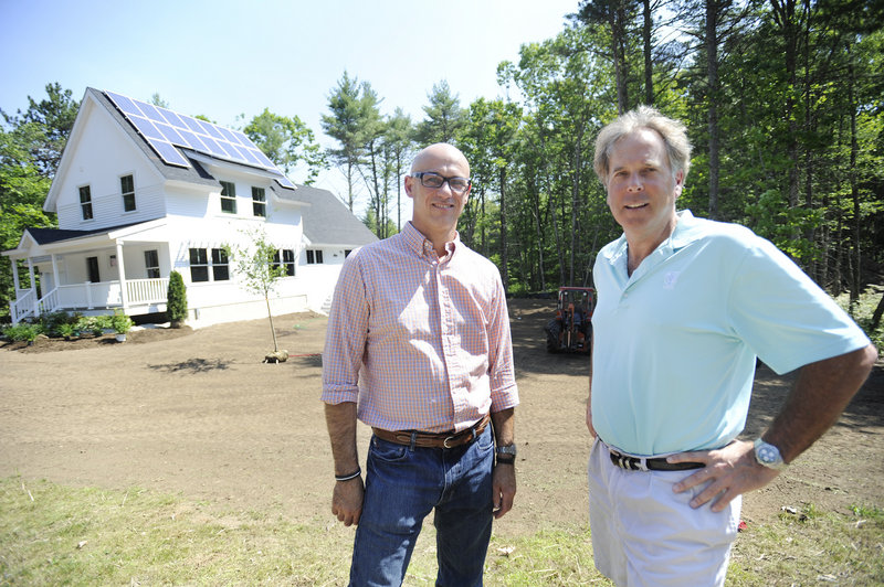 Jesse Ware, left, of JP Ware Design, and Craig Briggs, of CB Builders, stand near a model of a “net-zero” high-efficiency home at Brackett Estates in Wells. They have teamed up to form Futuro Inc. and hope there’s enough interest to build 26 of the homes in the subdivision.
