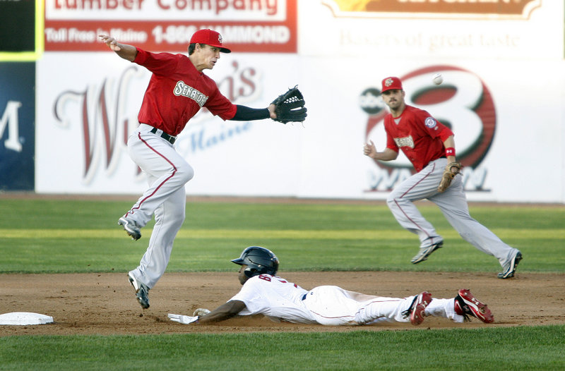 Jackie Bradley dives into second for a stolen base as Harrisburg shortstop Zach Walters chases the wild throw. Bradley was 1 for 4 in his first game with the Sea Dogs.