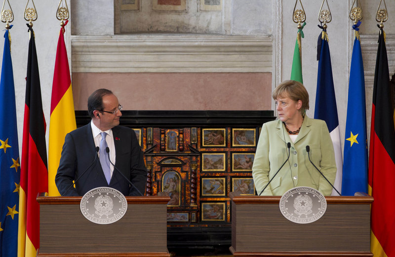 French President Francois Hollande, left, and German Chancellor Angela Merkel end a Friday meeting with Italian Premier Mario Monti and Spanish Premier Mariano Rajoy.
