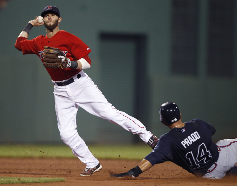 Dustin Pedroia of the Boston Red Sox throws to first in the fifth inning Friday night after forcing Martin Prado of the Atlanta Braves at second. The throw was too late to complete a double play on Dan Uggla. Atlanta won, 4-1.