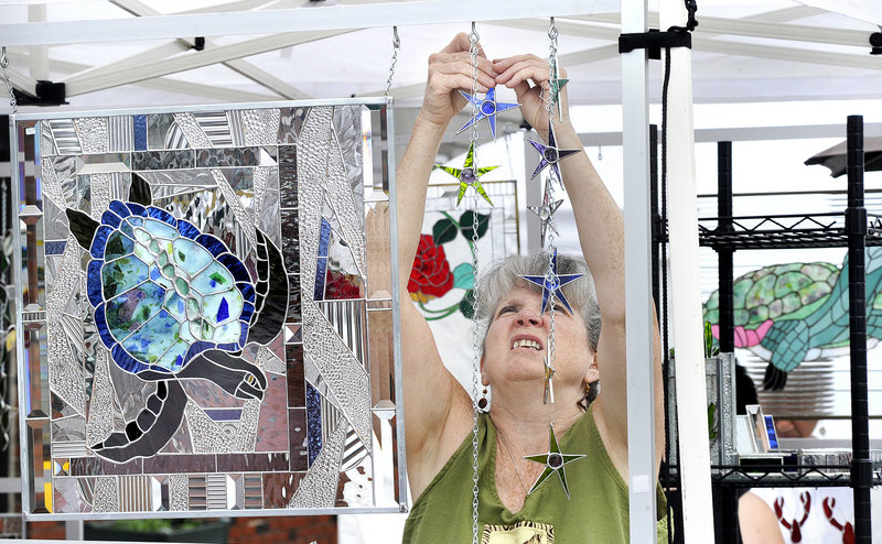 Stained glass artist Peggy Pulling of Gorham sets up her display at the 42nd Saco Arts Festival highlighting Saco’s 250th Anniversary Celebration.