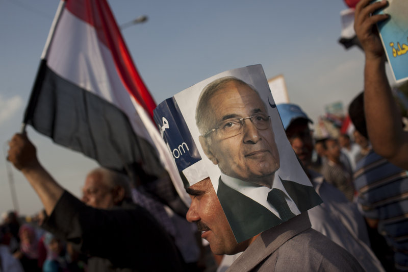 An Egyptian man wears a handmade hat with a picture of Egyptian presidential candidate Ahmed Shafik at a demonstration in Cairo, Egypt, on Saturday.