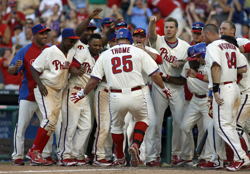 Jim Thome is greeted at the plate after his home run in the bottom of the ninth inning Saturday gave the Phillies a 7-6 victory over the Tampa Bay Rays.