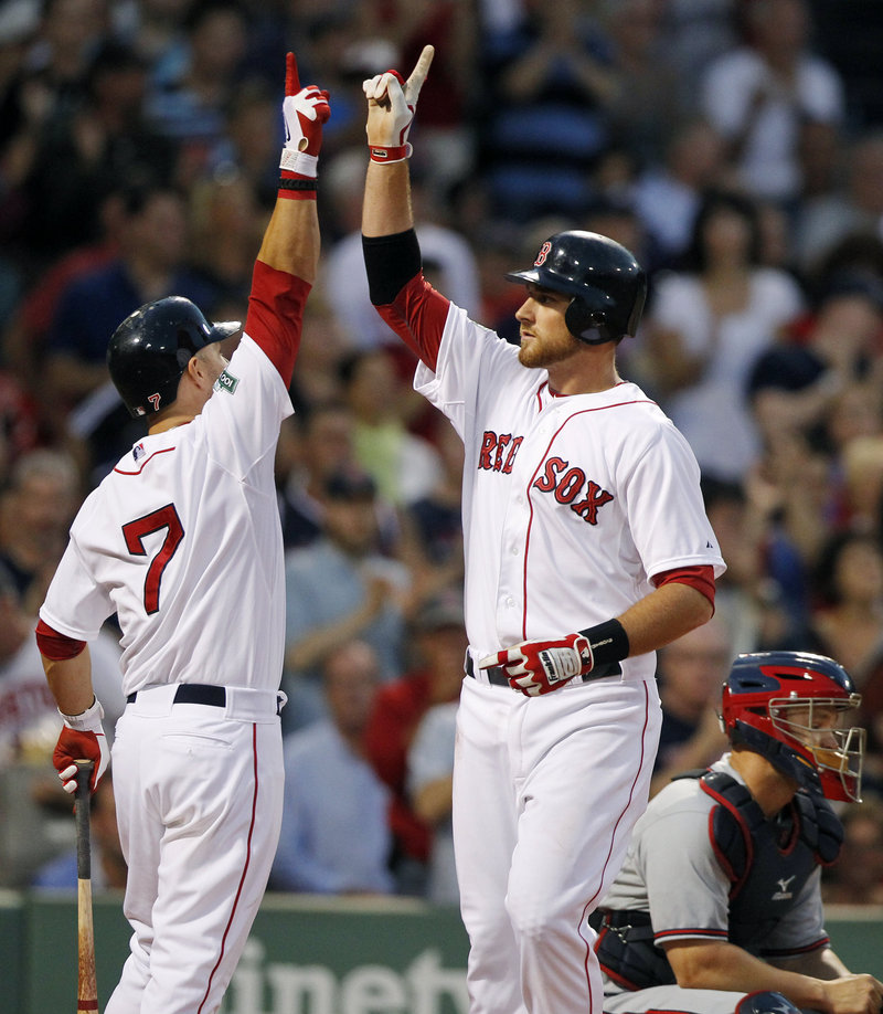 Will Middlebrooks, right, celebrates with Cody Ross after hitting a home run Saturday night, helping the Red Sox to an 8-4 win over the Braves.