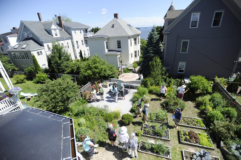 Visitors walk through the garden of Steven Goodman and Jane Bayer on Morning Street during the Hidden Gardens of Munjoy Hill Tour on Sunday in Portland. The participants got a peek at landscapes that are usually hidden from public view.